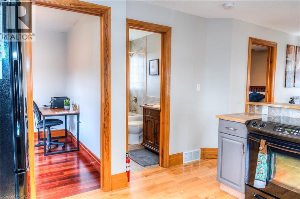 Light wood-finish flooring extending into a dedicated nook featuring a rich wood-finish floor - 46 2 Avenue, Kitchener, ON - Indoor Photo Showing Kitchen