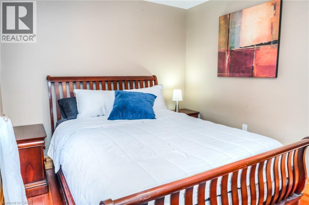 Hardwood flooring with a rich finish - 46 2 Avenue, Kitchener, ON - Indoor Photo Showing Bedroom