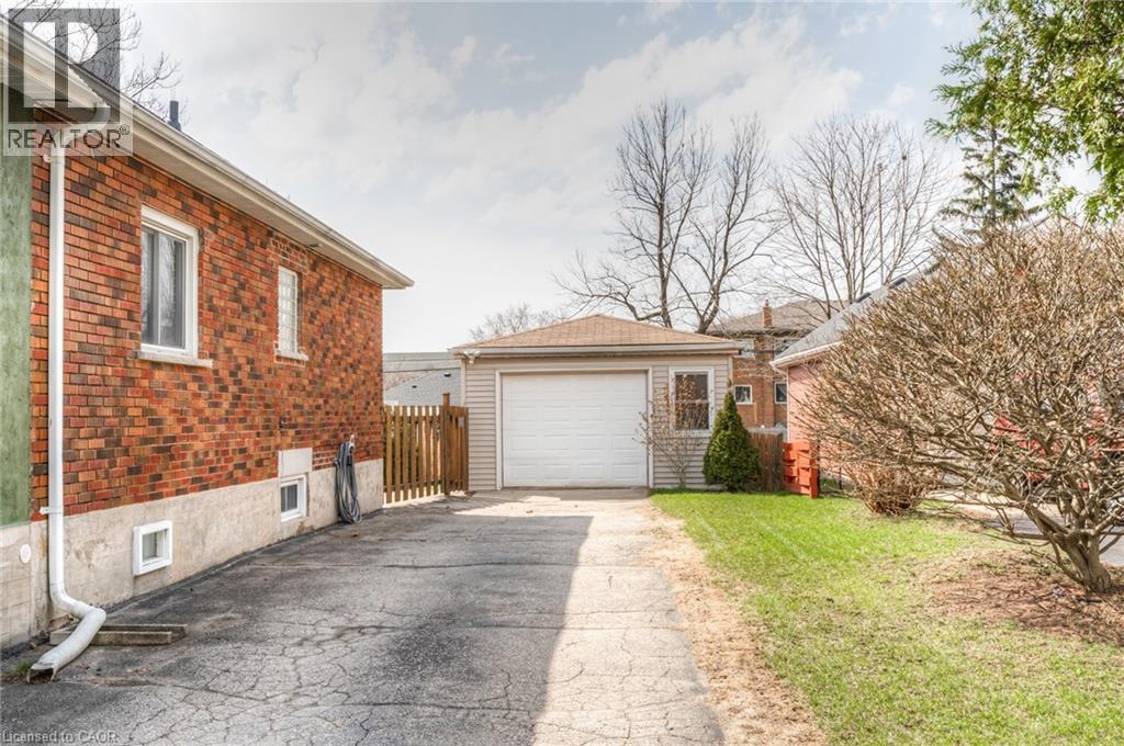 Detached garage with a white overhead door and siding exterior - 46 2 Avenue, Kitchener, ON - Outdoor