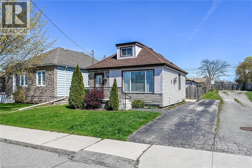 Front exterior featuring horizontal siding, a dormer window, and a shingled roof - 192 Ivon Avenue, Hamilton, ON - Outdoor