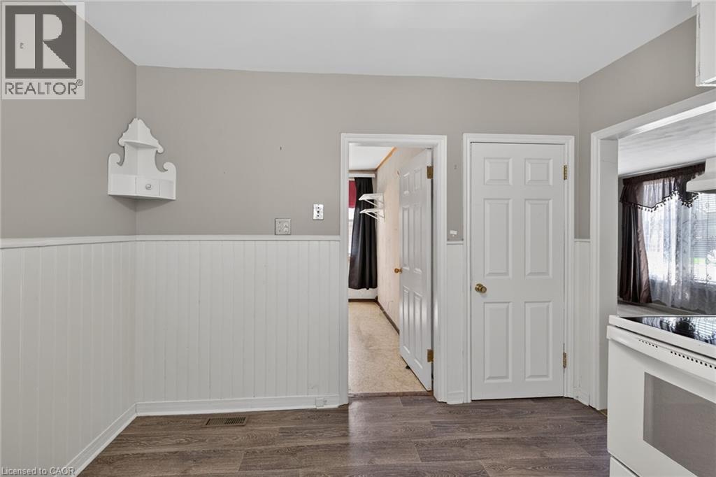 Wood-finish flooring paired with white beadboard wainscoting and light gray wall paint - 192 Ivon Avenue, Hamilton, ON - Indoor
