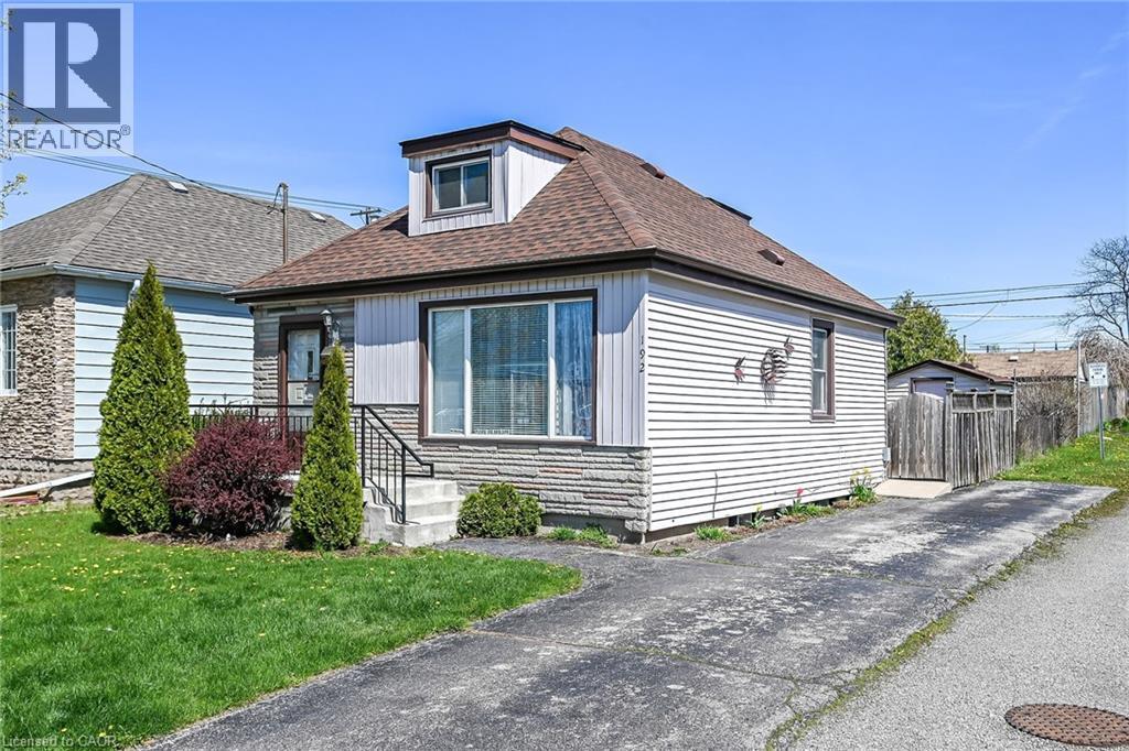 Single-story home featuring a dormer window, stone facade accents, and horizontal siding - 192 Ivon Avenue, Hamilton, ON - Outdoor