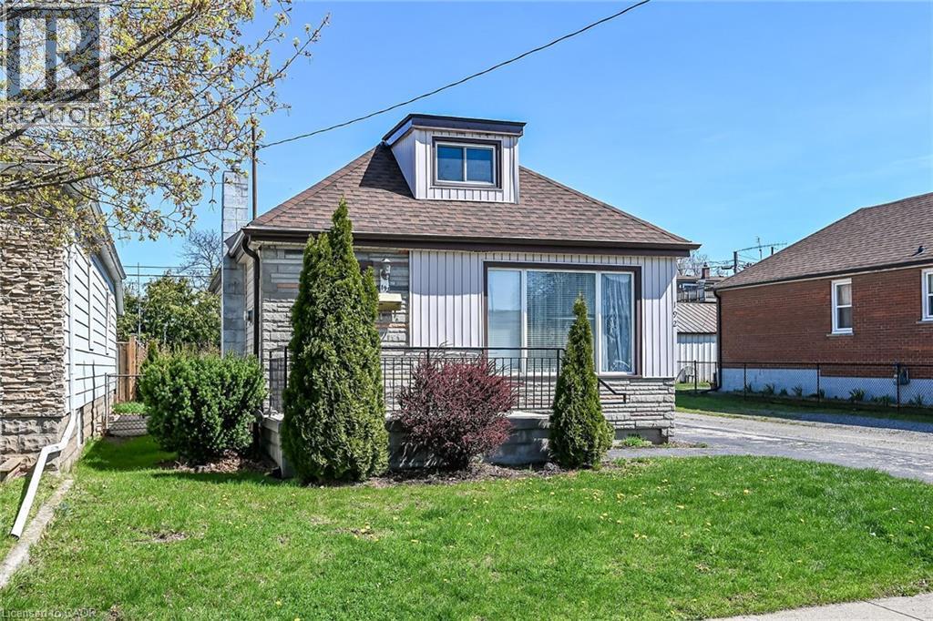 Front elevation featuring vertical siding and stone veneer accents - 192 Ivon Avenue, Hamilton, ON - Outdoor