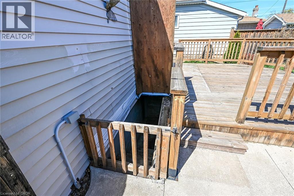 Exterior wood deck with a built-in gate and steps, alongside a white siding wall - 192 Ivon Avenue, Hamilton, ON - Outdoor With Deck Patio Veranda With Exterior
