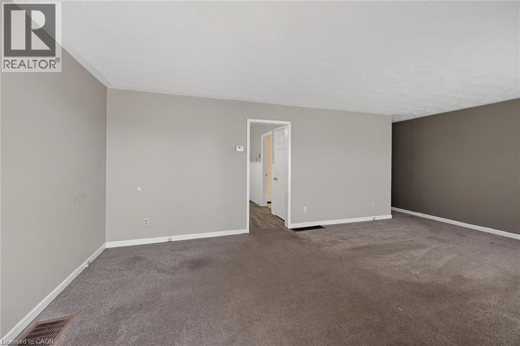 Spacious room featuring carpeting, neutral wall colors, and white trim - 192 Ivon Avenue, Hamilton, ON - Indoor Photo Showing Other Room
