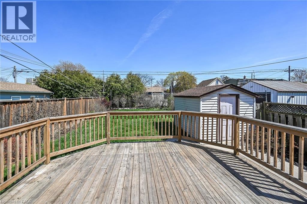 Expansive wooden deck with a built-in railing, overlooking a fenced backyard with a shed - 192 Ivon Avenue, Hamilton, ON - Outdoor With Deck Patio Veranda With Exterior