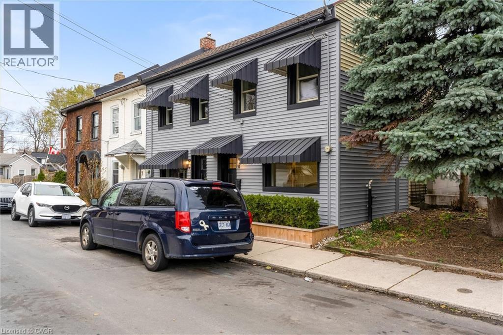 Two-story residential facade featuring horizontal siding and dark window awnings - 11 Ford Street, Hamilton, ON - Outdoor