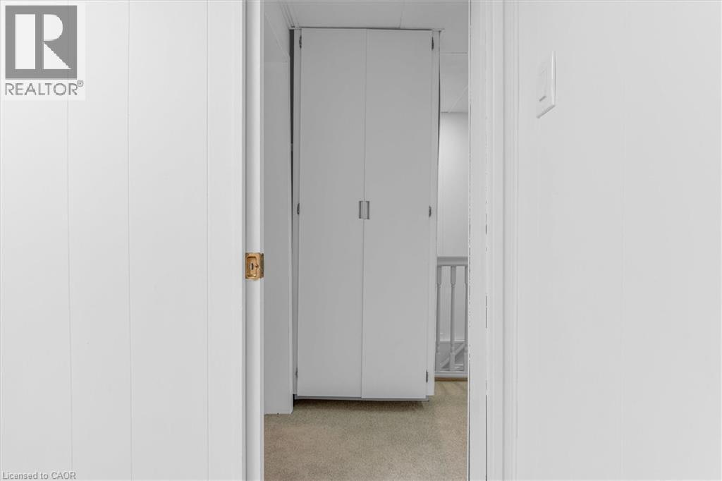 White paneled walls framing a doorway with a brass latch - 11 Ford Street, Hamilton, ON - Indoor Photo Showing Other Room