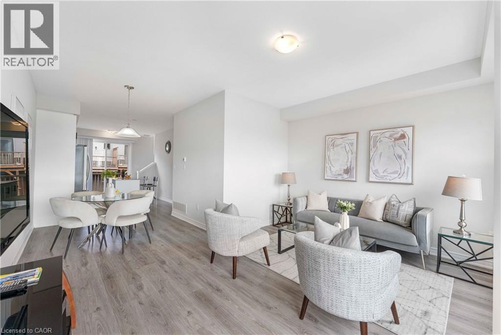 Open-concept living area with light-toned wood-finish flooring, recessed lighting, and white wall finishes - 50 Hollywood Court, Cambridge, ON - Indoor Photo Showing Living Room