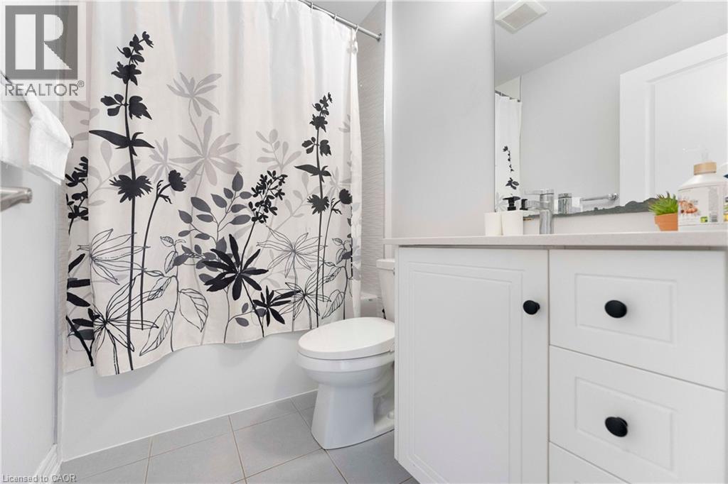 Bathroom featuring a white vanity with black hardware, a light-colored countertop, and a built-in sink with a chrome faucet - 50 Hollywood Court, Cambridge, ON - Indoor Photo Showing Bathroom