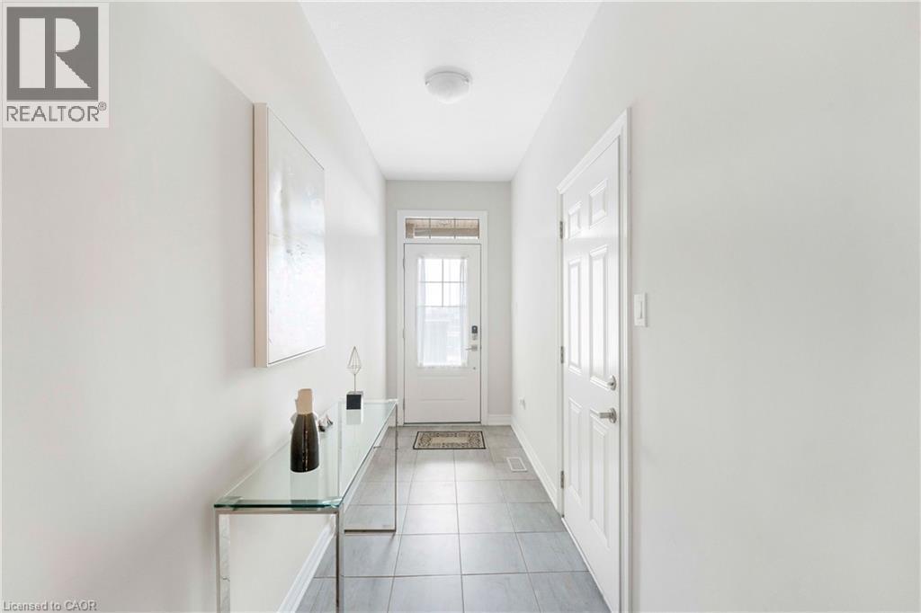 Inviting entryway featuring light gray wall paint, a white paneled door, and a white front door with upper glass inserts - 50 Hollywood Court, Cambridge, ON - Indoor Photo Showing Other Room