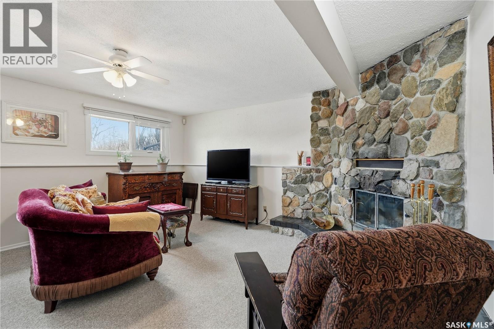 110 Mccarthy Boulevard N, Regina, SK - Indoor Photo Showing Living Room With Fireplace