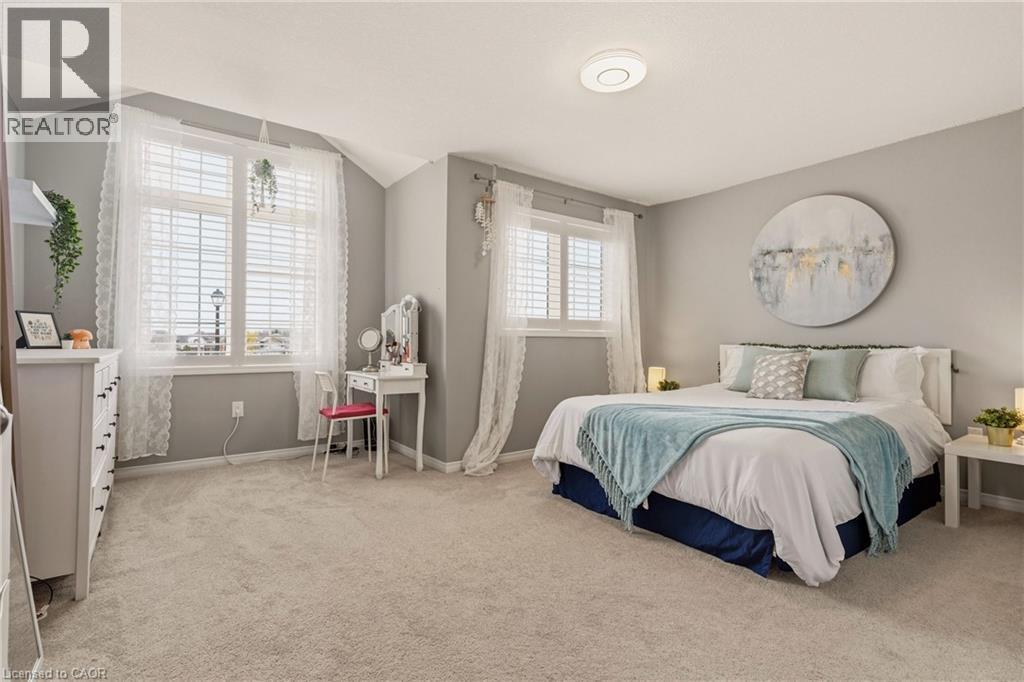 Spacious bedroom featuring light neutral wall tones and soft carpet flooring - 42 Yager Drive, Binbrook, ON - Indoor Photo Showing Bedroom