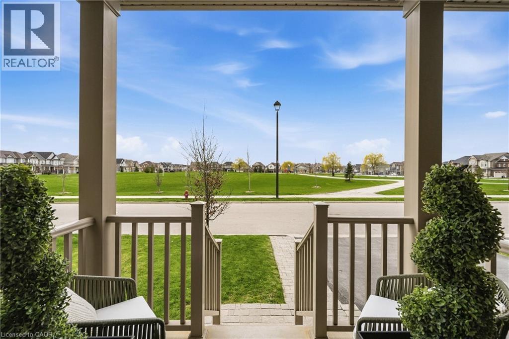 Covered porch with square columns and vertical railings - 42 Yager Drive, Binbrook, ON - Outdoor With Exterior