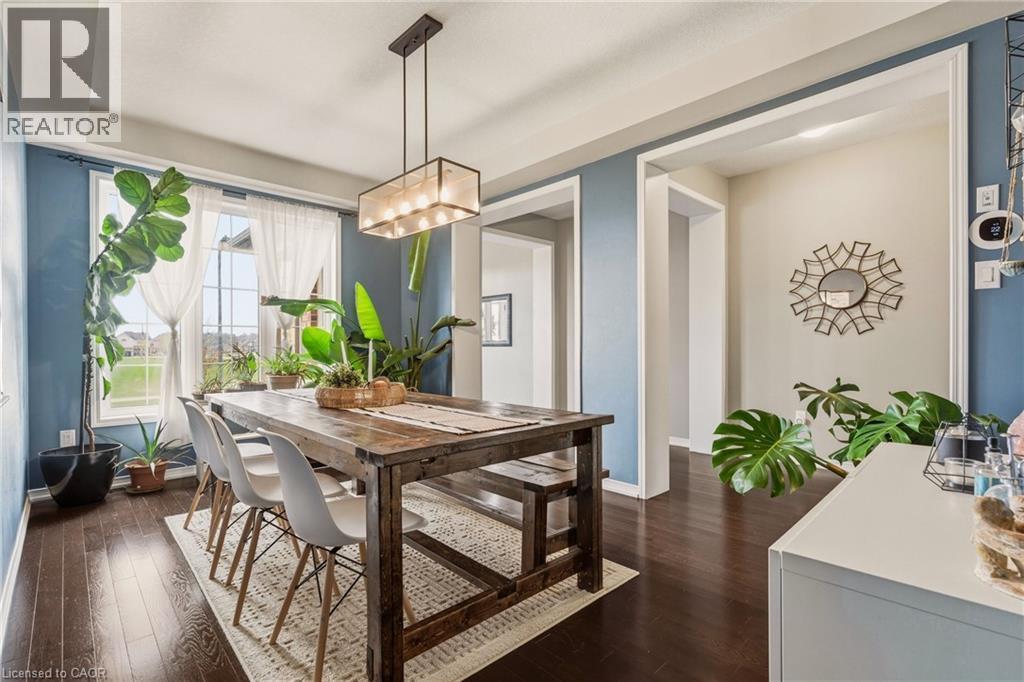 Formal dining space featuring dark wood-finish flooring - 42 Yager Drive, Binbrook, ON - Indoor Photo Showing Dining Room