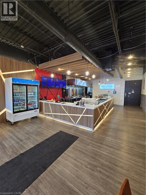 Commercial space featuring a prominent service counter with integrated lighting and a wood-finish facade - 100 Mearns Avenue Unit# 5, Clarington, ON