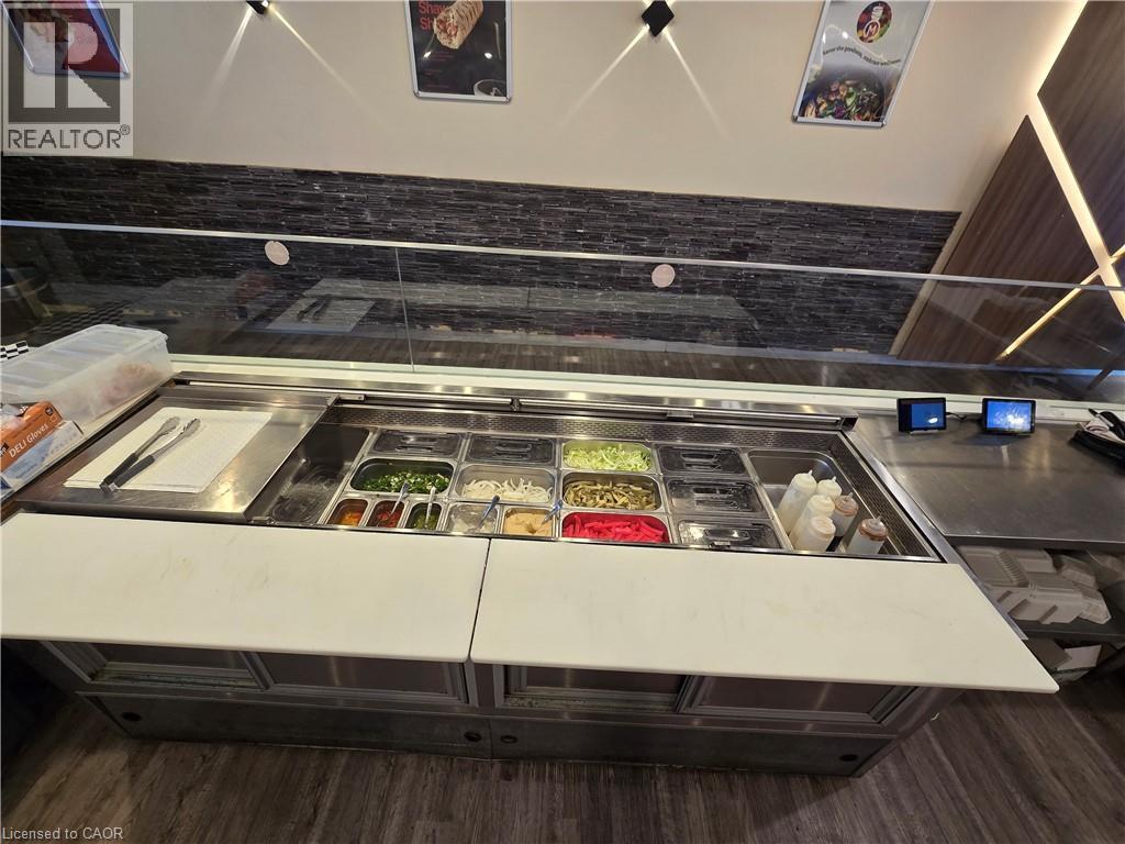 Stainless steel counter with built-in food prep stations featuring multiple ingredient bins - 100 Mearns Avenue Unit# 5, Clarington, ON