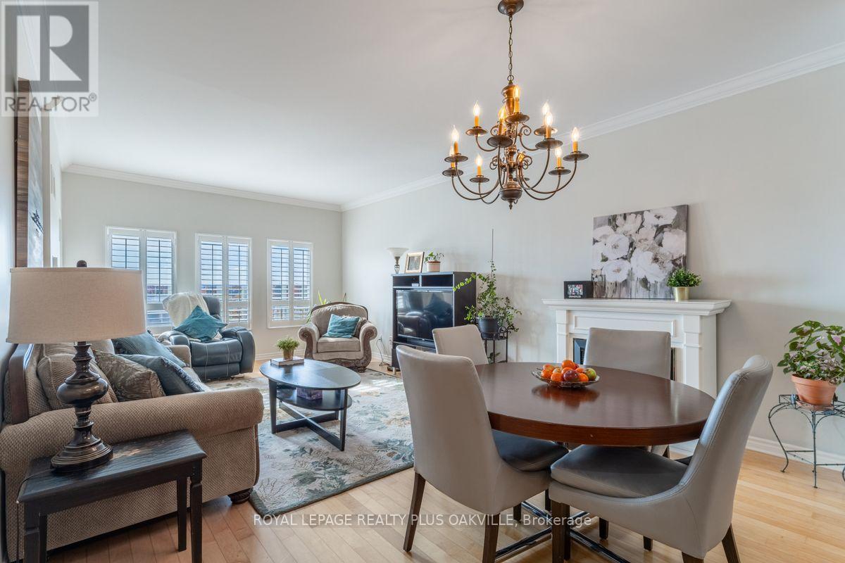 403 - 1499 Nottinghill Gate, Oakville, ON - Indoor Photo Showing Dining Room With Fireplace