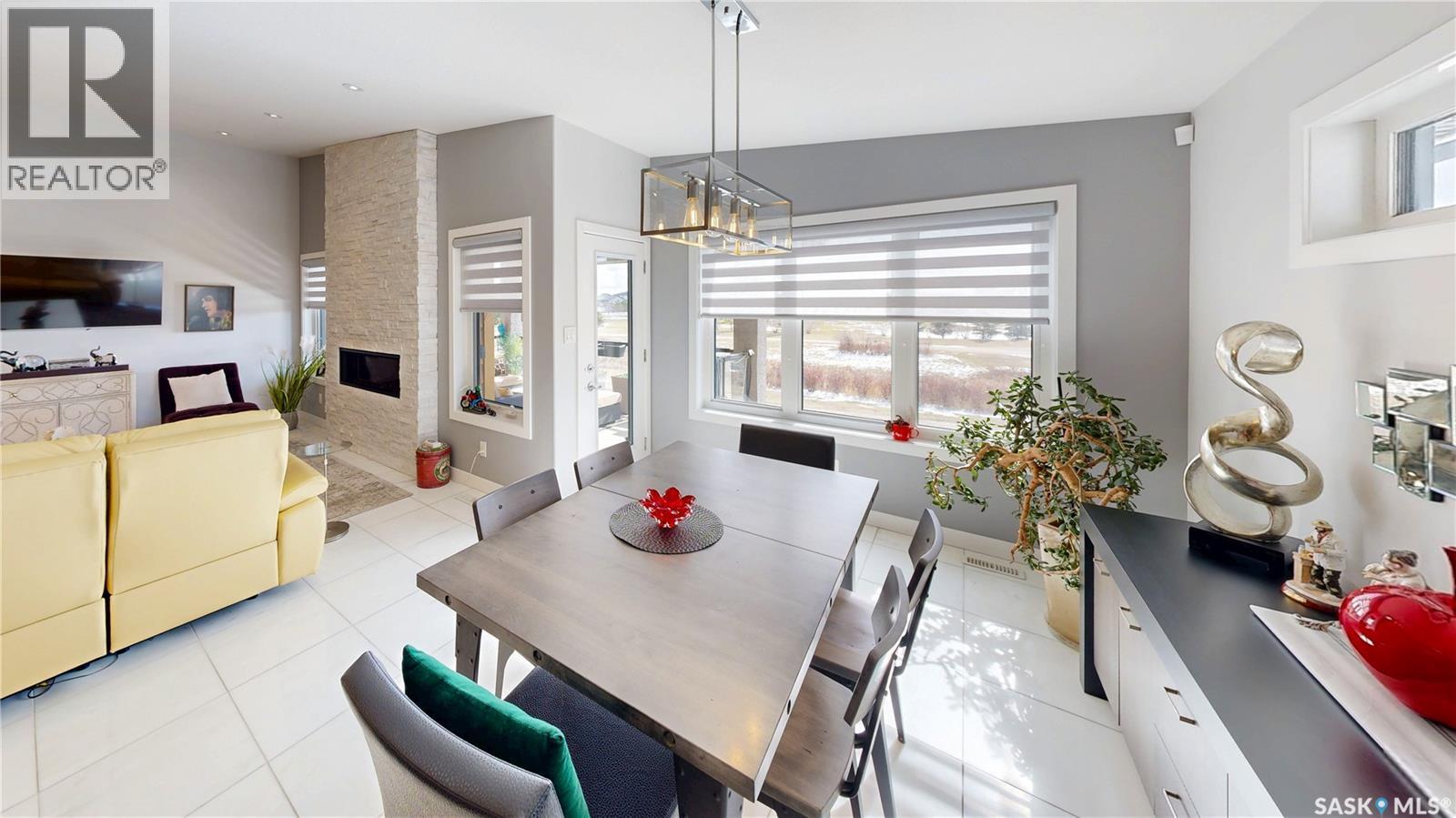4369 Albulet Drive, Regina, SK - Indoor Photo Showing Dining Room With Fireplace
