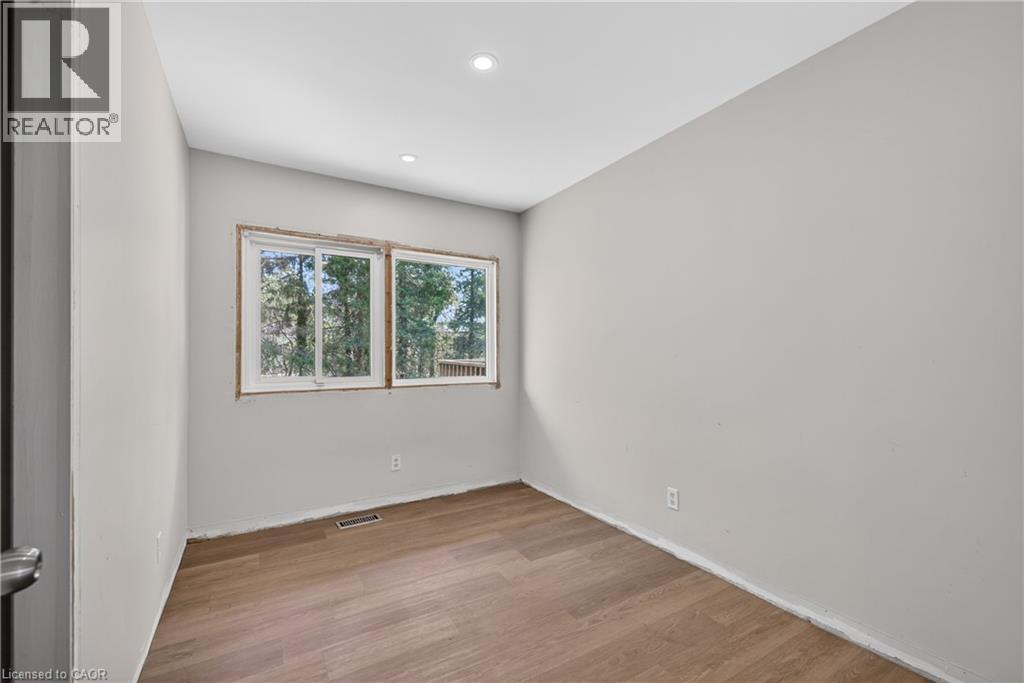 Room with light gray walls, wood-finish flooring, and recessed ceiling lighting - 515 Bobbybrook Drive, London, ON - Indoor Photo Showing Other Room