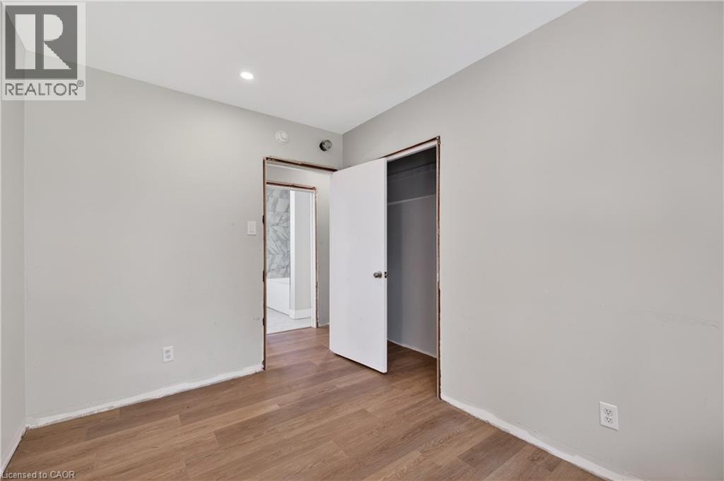 Interior room with wood-finish flooring and light gray walls - 515 Bobbybrook Drive, London, ON - Indoor Photo Showing Other Room