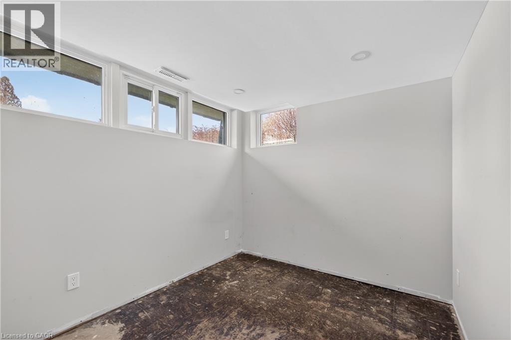 Room featuring multiple windows for natural light, recessed ceiling lighting, light gray painted walls, and a concrete subfloor - 515 Bobbybrook Drive, London, ON - Indoor Photo Showing Other Room