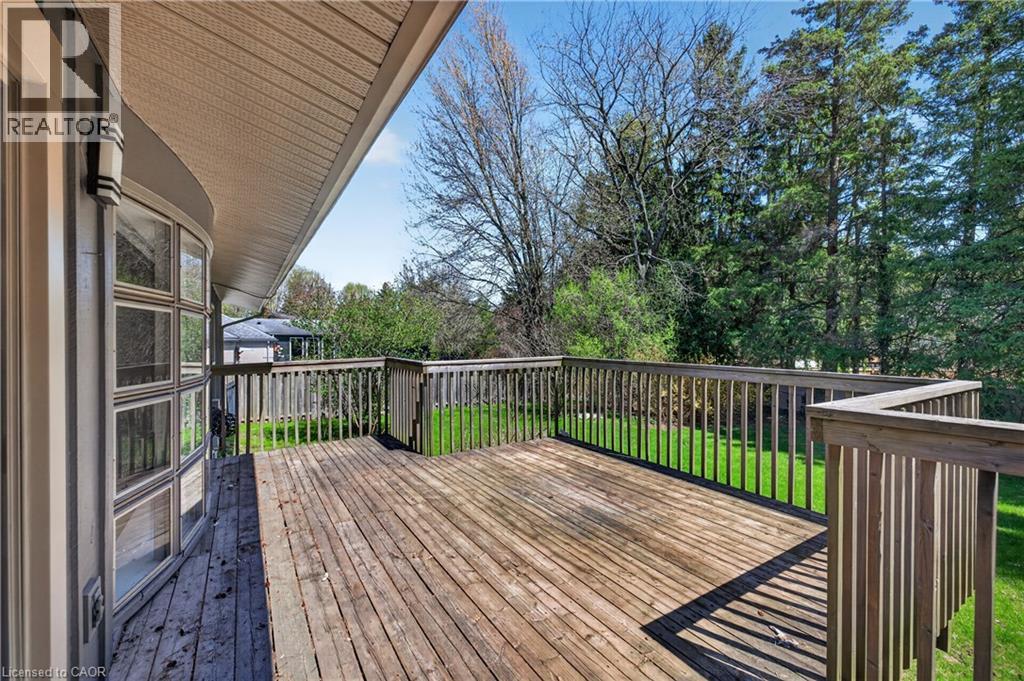 Expansive wood deck with a full railing system, featuring an integrated gate - 515 Bobbybrook Drive, London, ON - Outdoor With Deck Patio Veranda With Exterior