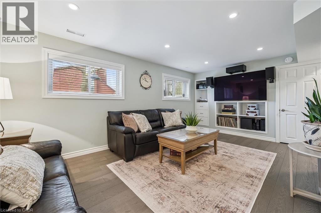 Recessed lighting illuminates the wood-finish flooring and light-toned walls - 574 Sprucehill Avenue, Waterloo, ON - Indoor Photo Showing Living Room