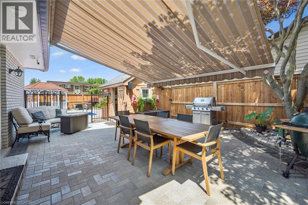 Paver patio with a retractable awning providing extensive coverage - 574 Sprucehill Avenue, Waterloo, ON - Outdoor With Deck Patio Veranda With Exterior