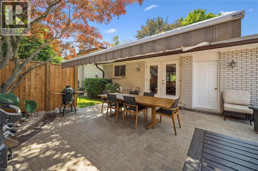 Expansive paved patio with brick exterior and dual French doors - 574 Sprucehill Avenue, Waterloo, ON - Outdoor With Deck Patio Veranda With Exterior