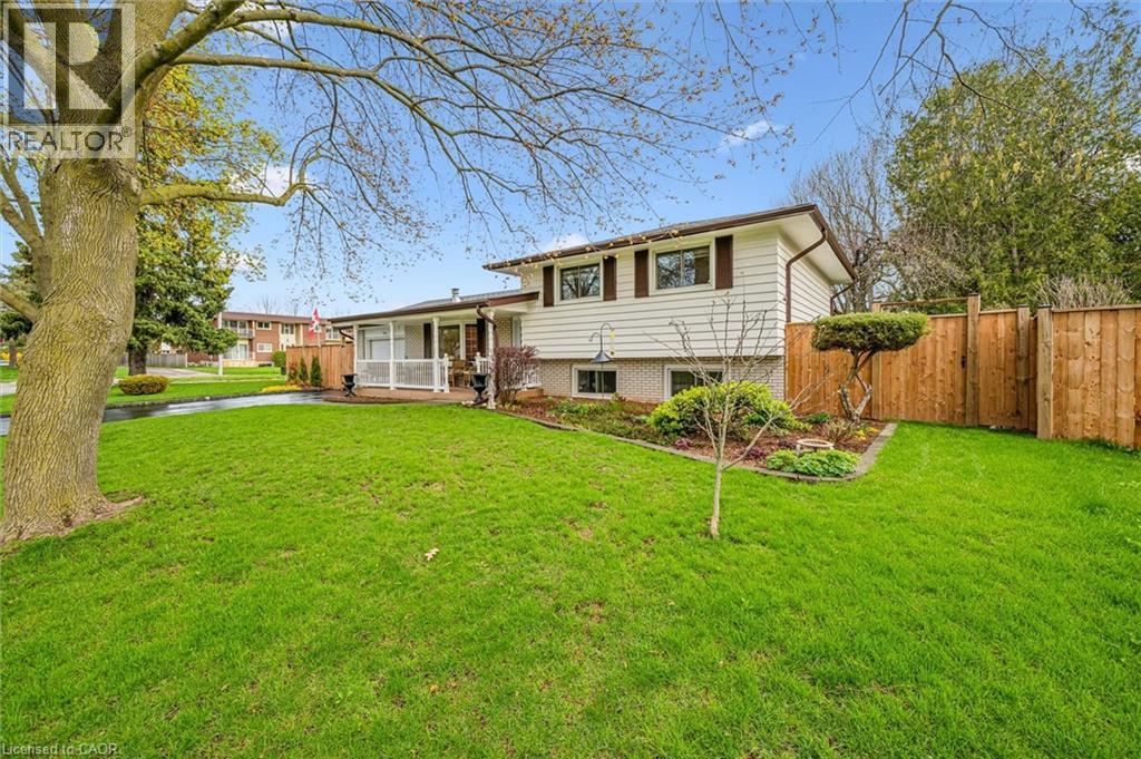 Front exterior with white siding and dark brown trim accents - 574 Sprucehill Avenue, Waterloo, ON - Outdoor