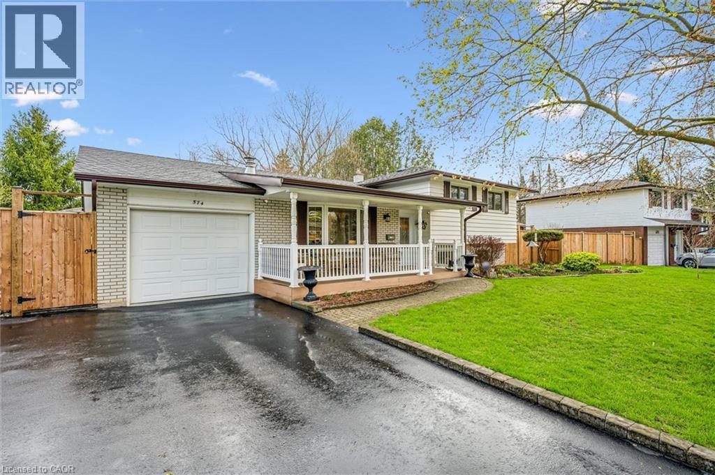 Ranch-style exterior with a white brick facade and dark trim - 574 Sprucehill Avenue, Waterloo, ON - Outdoor With Deck Patio Veranda