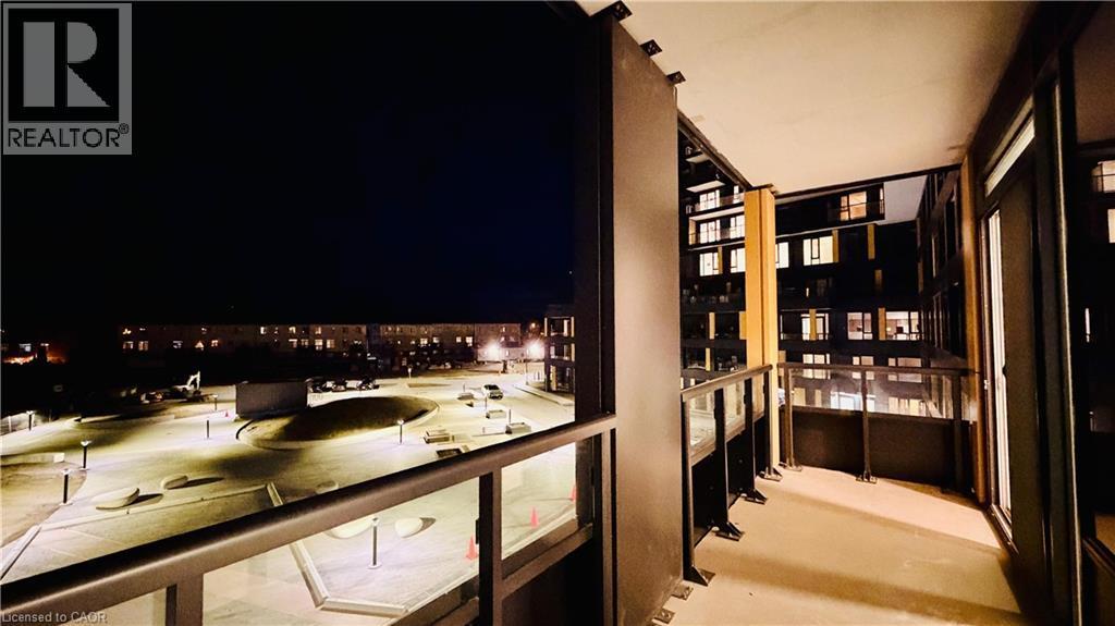 Private balcony featuring glass railings and exterior lighting - 4878 Powers Common Unit# 301, Burlington, ON -