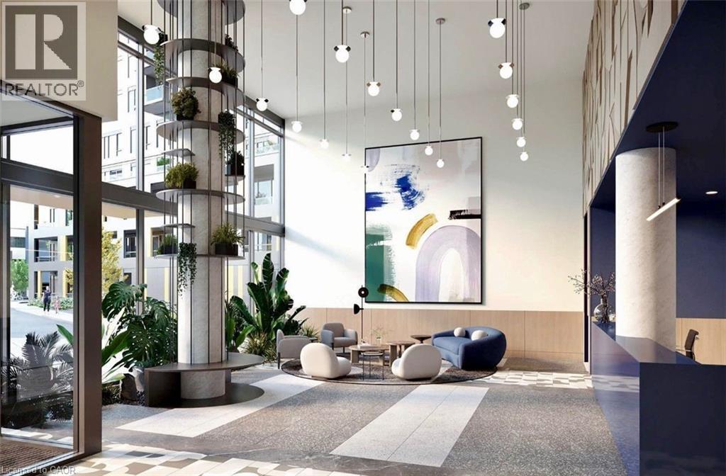 Lobby area featuring an integrated vertical planter column, high ceilings with pendant lighting, and full-height windows - 4878 Powers Common Unit# 301, Burlington, ON - Indoor Photo Showing Other Room