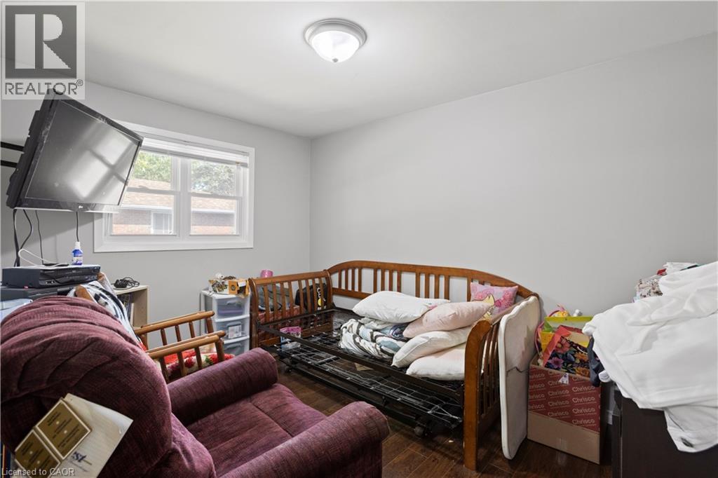 Interior room featuring wood-finish flooring, light gray wall paint, and a ceiling-mounted light fixture - 179 Vancouver Street, London, ON - Indoor Photo Showing Bedroom
