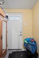 White entry door with decorative glass panel and satin nickel hardware -