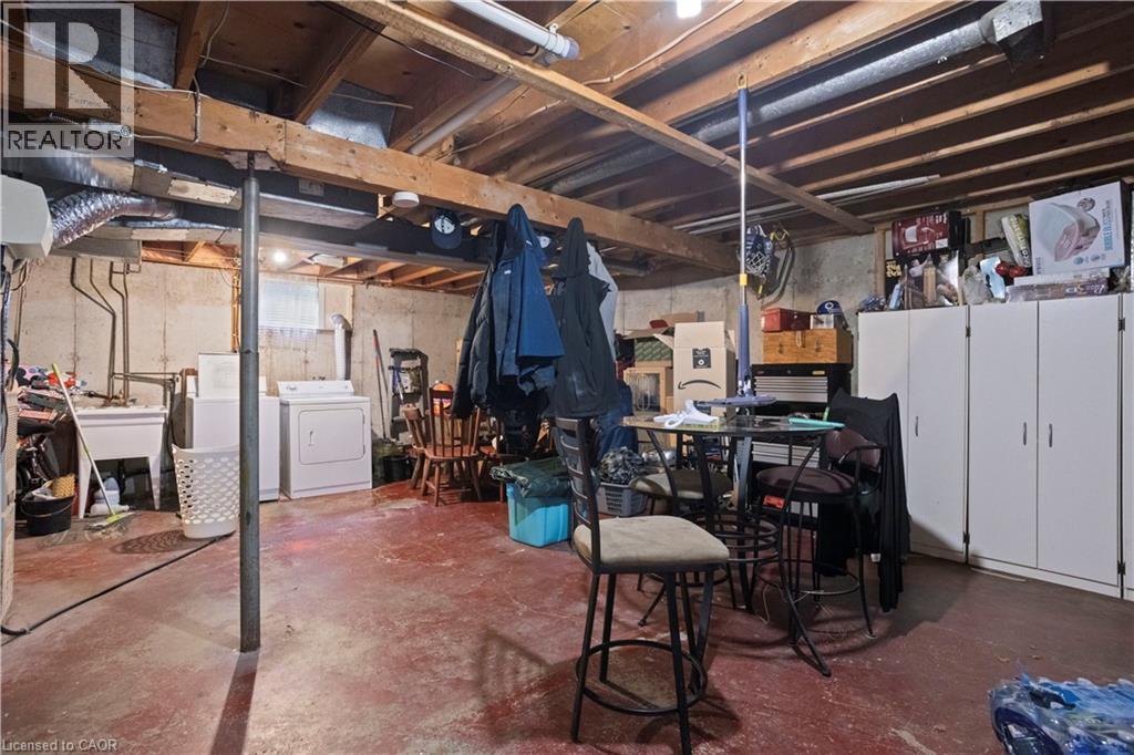 Basement area featuring a concrete foundation, exposed ceiling joists, and a utility sink - 179 Vancouver Street, London, ON - Indoor Photo Showing Basement