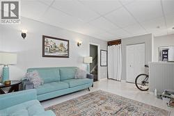 Finished interior space featuring light-colored walls and wood-finish flooring -