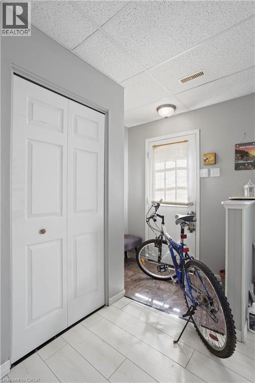 Entryway featuring light-toned wood-finish flooring, a bi-fold closet, and neutral gray wall paint - 179 Vancouver Street, London, ON - Indoor Photo Showing Other Room