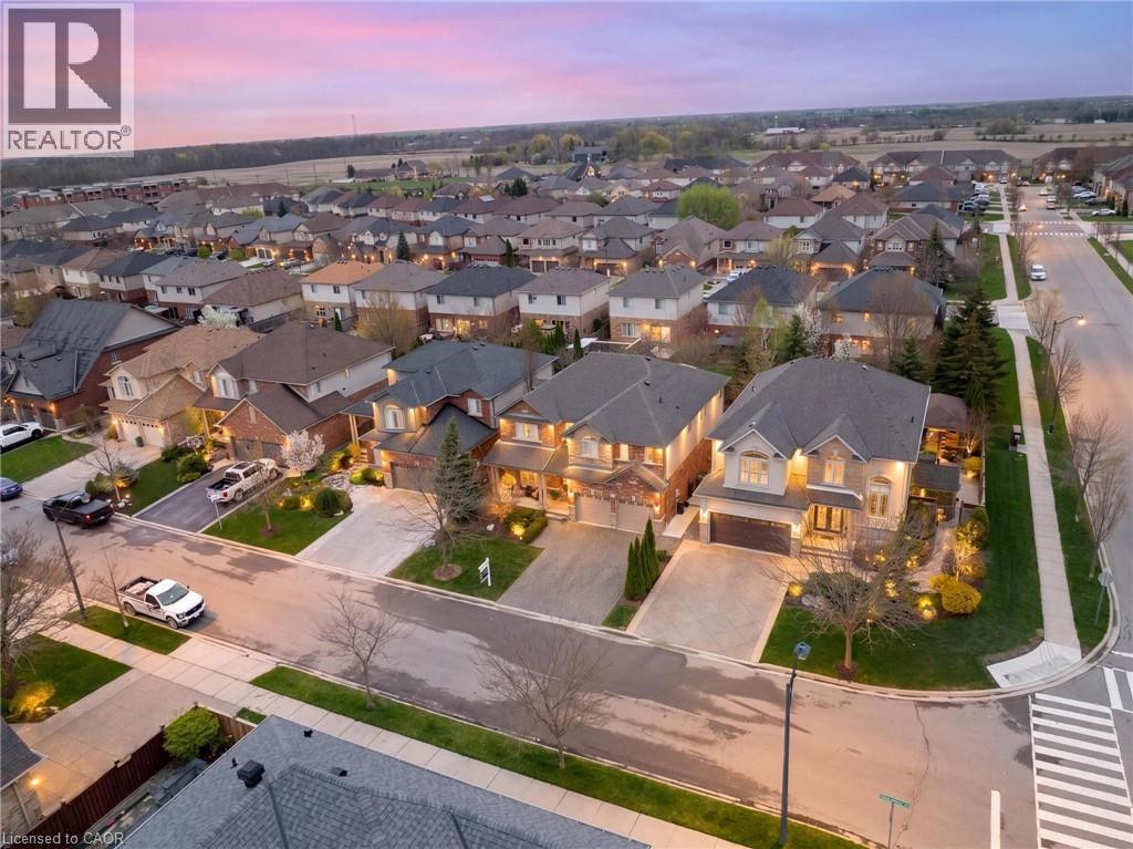Residential streetscape featuring numerous detached homes with varied architectural styles - 129 Magnificent Way, Binbrook, ON - Outdoor With View
