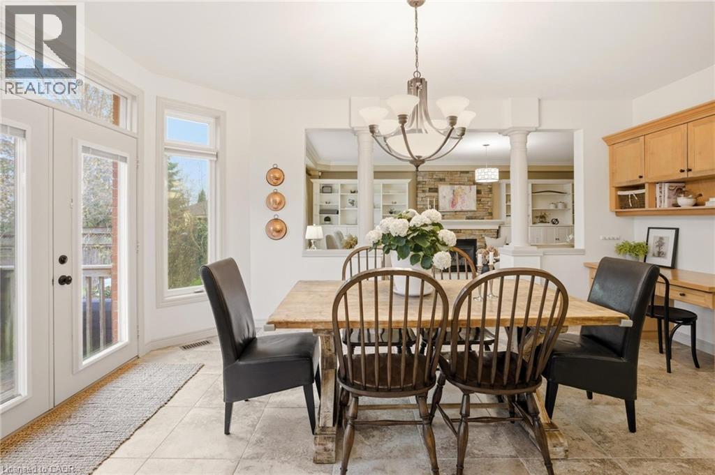 Dining area featuring neutral-toned tile flooring, a multi-pane glass door, and a multi-pane window - 129 Magnificent Way, Binbrook, ON - Indoor Photo Showing Dining Room