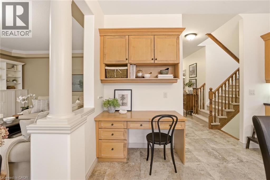 Built-in desk area featuring natural wood cabinetry with upper storage and open shelving - 129 Magnificent Way, Binbrook, ON - Indoor Photo Showing Other Room