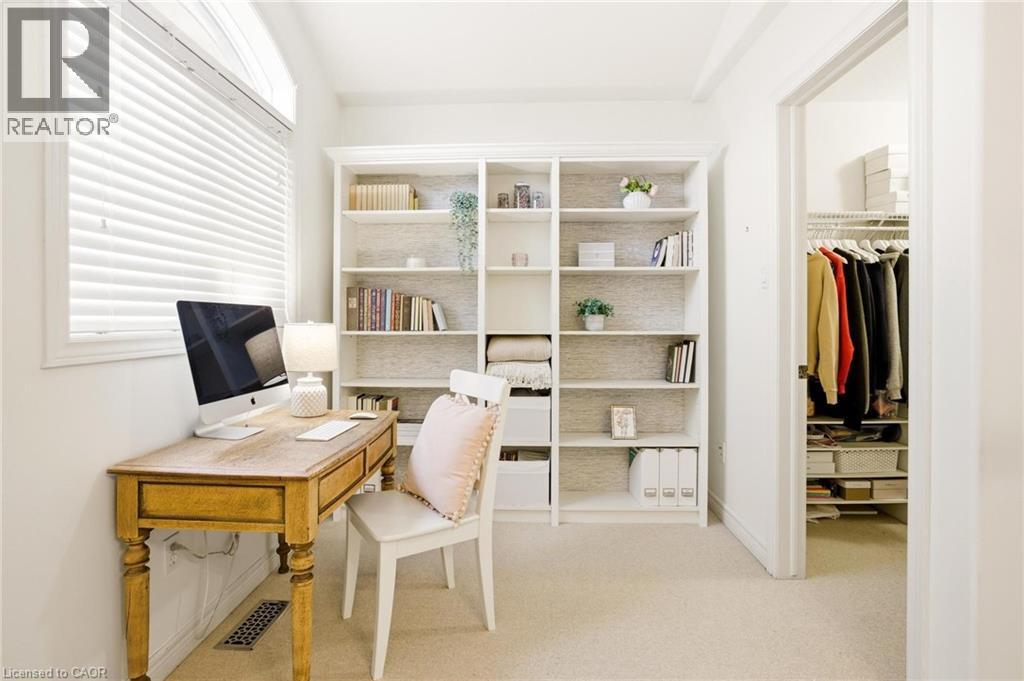 Dedicated room featuring built-in shelving, carpet flooring, a window with blinds, and a built-in closet with wire shelving - 129 Magnificent Way, Binbrook, ON - Indoor Photo Showing Office