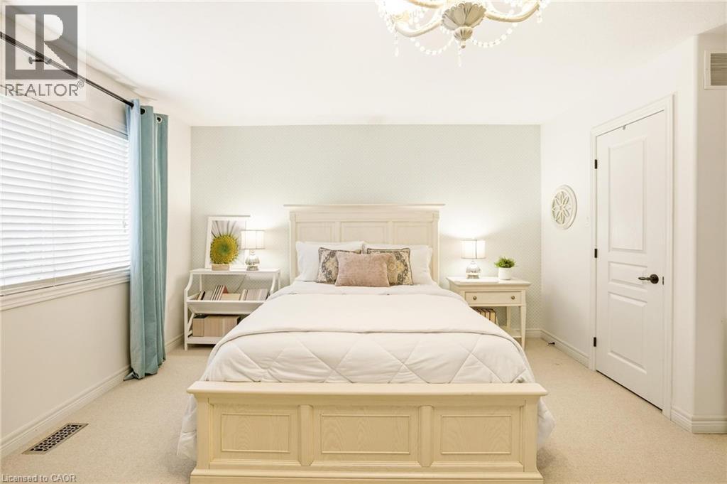 Bright bedroom featuring carpeted flooring and a window with blinds - 129 Magnificent Way, Binbrook, ON - Indoor Photo Showing Bedroom