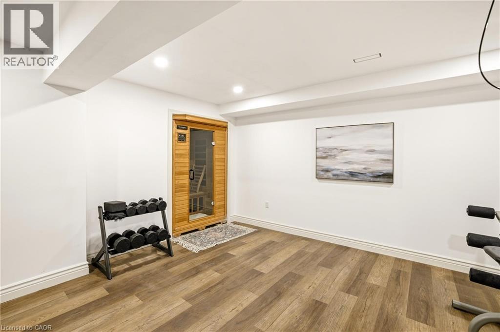 Dedicated wellness space featuring wood-finish flooring and recessed lighting - 129 Magnificent Way, Binbrook, ON - Indoor