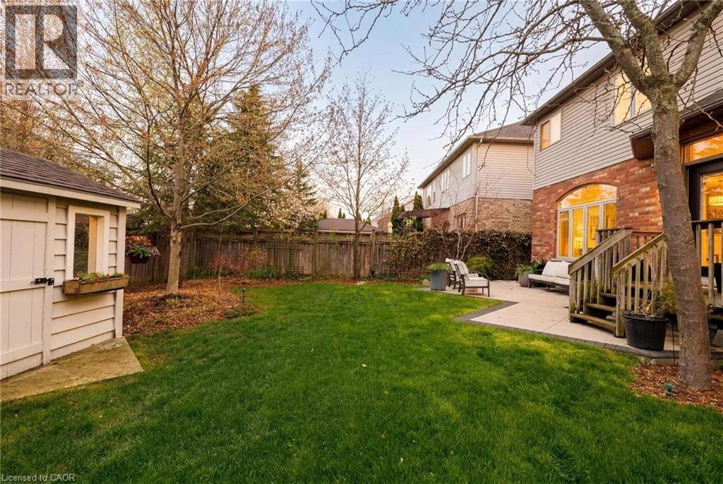 Expansive green lawn with mature trees and a privacy fence - 129 Magnificent Way, Binbrook, ON - Outdoor
