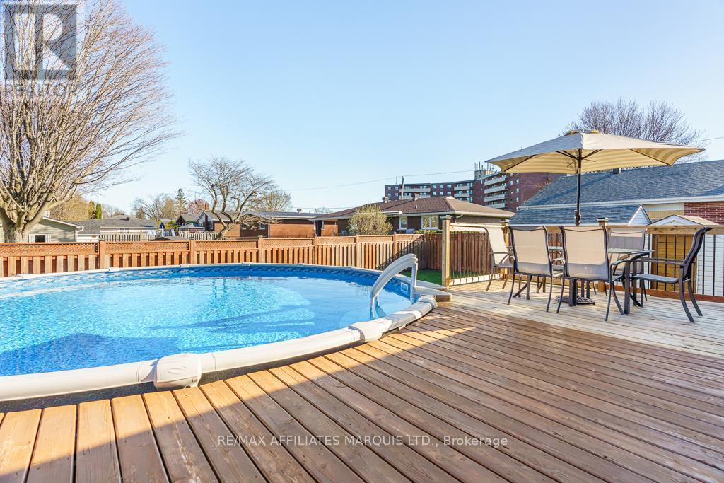 Pool deck with dining area - 1503 Second Street E, Cornwall, ON - Outdoor With Above Ground Pool With Deck Patio Veranda