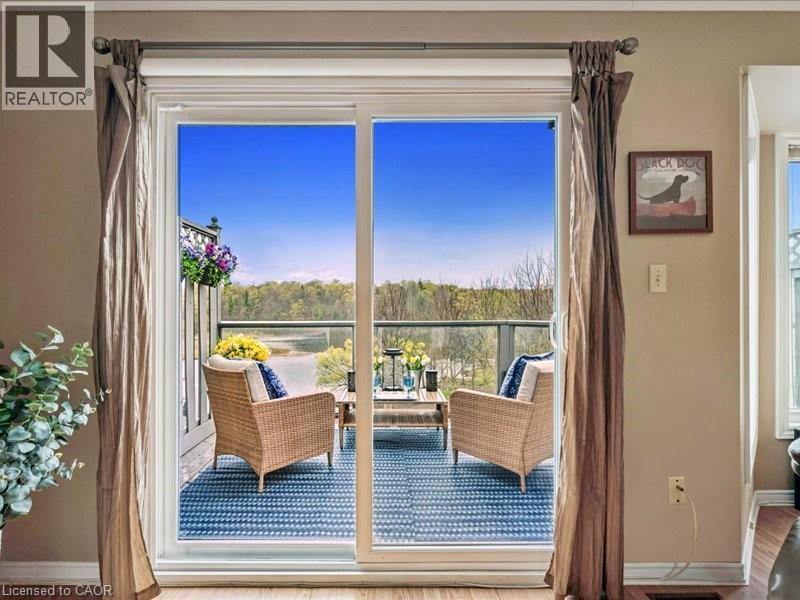 Sliding glass door off living/dining room opening to an outdoor balcony with a glass railing - 245 Bishop Street S Unit# 4, Cambridge, ON - Indoor Photo Showing Other Room
