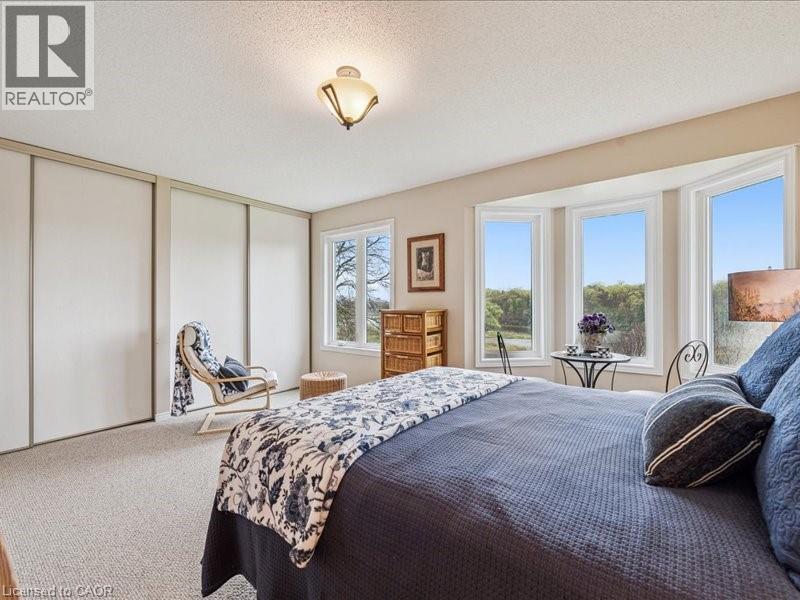 Amazing morning sunrise views over The Grand River from your Primary Bedroom - 245 Bishop Street S Unit# 4, Cambridge, ON - Indoor Photo Showing Bedroom