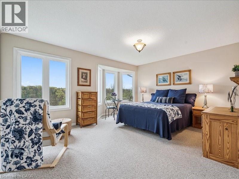 Carpeted room with a bay window, additional large windows, and neutral wall paint - 245 Bishop Street S Unit# 4, Cambridge, ON - Indoor Photo Showing Bedroom